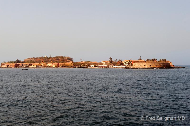 20090528_101742 D3 P1 P1.jpg - Our first view of the imposing Goree island.  It was a transfer point of slaves from Africa to the New World.  There is today the historical controversy whether Goree Island was the epicenter of the slave trade and just how vital and important was Goree Island. Suffice it to realize that geographically it was the closest African port to America and very convenient to Europe.  And it is indisputable that slaves were sent out from Goree by what remains here today  of the 39 slave buildings.  There is even some of the writings on the walls of these slave houses by the people who were imprisoned here